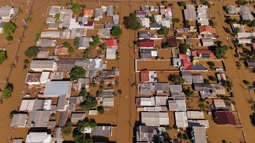 Aerial view of floods in Eldorado do Sul, Rio Grande do Sul state, Brazil, taken on May 9, 2024. Teams raced against the clock Thursday to deliver aid to flood-stricken communities in southern Brazil before the arrival of new storms forecast to batter the region again. Some 400 municipalities have been affected by the worst natural calamity ever to hit the state of Rio Grande do Sul, with at least 107 people dead and hundreds injured.Teams raced against the clock Thursday to deliver aid to flood-stricken communities in southern Brazil before the arrival of new storms forecast to batter the region again. Some 400 municipalities have been affected by the worst natural calamity ever to hit the state of Rio Grande do Sul, with at least 107 people dead and hundreds injured. (Photo by Carlos FABAL / AFP)