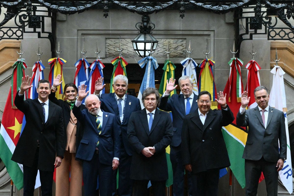 (L to R back) Ecuador's Vice President Maria Jose Pinto, Panama's President Jose Raul Mulino, and Chile's Foreign Minister Alberto van Klaveren; (L to R front) Paraguay's President Santiago Pena, Brazil's President Luiz Inacio Lula da Silva, Argentina's President Javier Milei, Bolivia's President Luis Arce Catacora, and Uruguay's President Yamandu Orsi, wave as they pose for the family photo during the 66th Summit of Leaders of Mercosur and Associated States at the San Martin Palace in Buenos Aires on July 3, 2025. The fate of a landmark trade deal with the European Union, which France is trying to block, loomed over a gathering of South America's Mercosur bloc gathering. Brussels in December struck a deal with Mercosur's founding members to create a free trade zone of around 700 million consumers, though it still needs to be ratified by EU member states. (Photo by Luis ROBAYO / AFP)