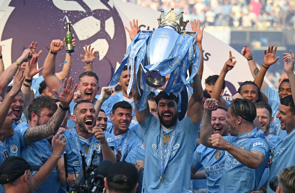 Manchester City's Croatian defender #24 Josko Gvardiol poses with the Premier League trophy after the presentation ceremony following the English Premier League football match between Manchester City and West Ham United at the Etihad Stadium in Manchester, north west England, on May 19, 2024. Manchester City created English football history on Sunday, beating West Ham 3-1 to win an unprecedented fourth straight Premier League title. (Photo by Oli SCARFF / AFP) / RESTRICTED TO EDITORIAL USE. No use with unauthorized audio, video, data, fixture lists, club/league logos or 'live' services. Online in-match use limited to 120 images. An additional 40 images may be used in extra time. No video emulation. Social media in-match use limited to 120 images. An additional 40 images may be used in extra time. No use in betting publications, games or single club/league/player publications. / 