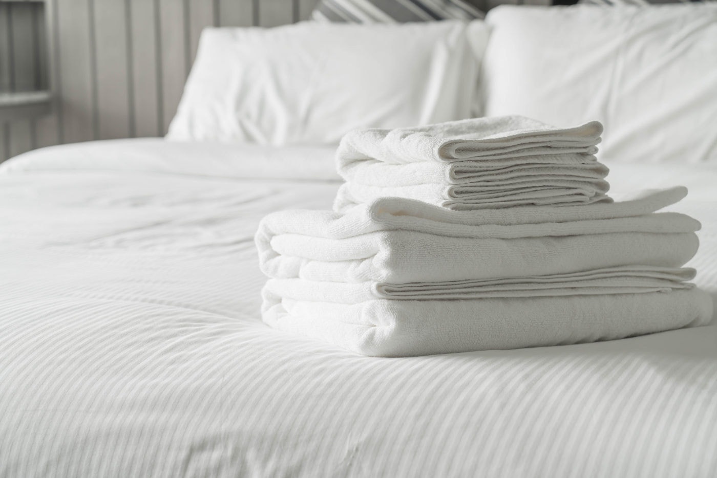 White towel on bed decoration in bedroom interior - Vintage light Filter