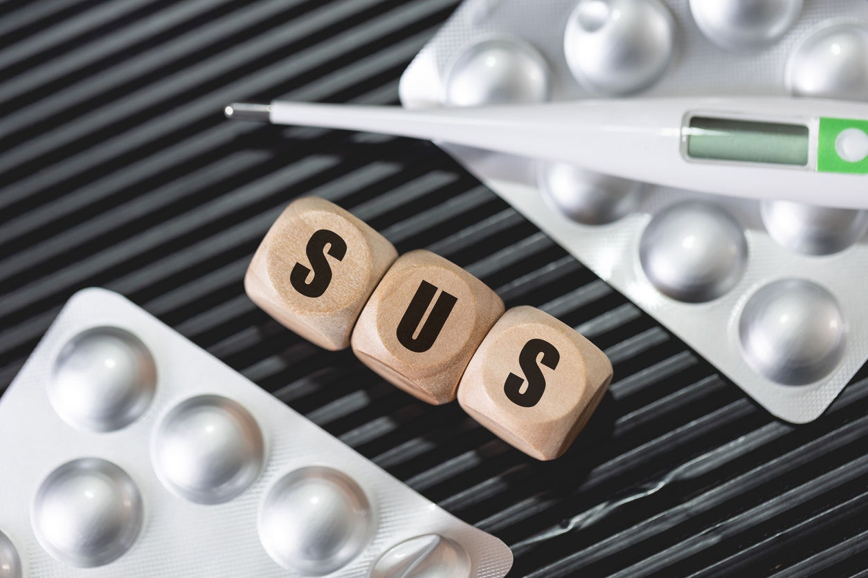 The abbreviation SUS written on wooden dice. Health Unic System ( Sistema Único de Saúde ). Public health.