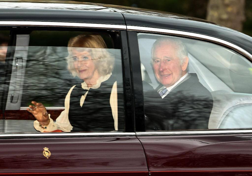 O rei Carlos III da Grã-Bretanha e a rainha Camilla da Grã-Bretanha acenam ao saírem de carro de Clarence House, em Londres