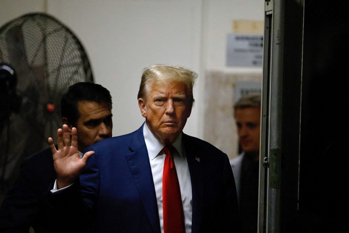 NEW YORK, NEW YORK - MAY 6: Former U.S. President Donald Trump gestures as he returns from a break in his trial for allegedly covering up hush money payments at Manhattan Criminal Court on May 6, 2024 in New York City. Trump was charged with 34 counts of falsifying business records last year, which prosecutors say was an effort to hide a potential sex scandal, both before and after the 2016 presidential election. Trump is the first former U.S. president to face trial on criminal charges.   Peter Foley-Pool/Getty Images/AFP (Photo by POOL / GETTY IMAGES NORTH AMERICA / Getty Images via AFP)