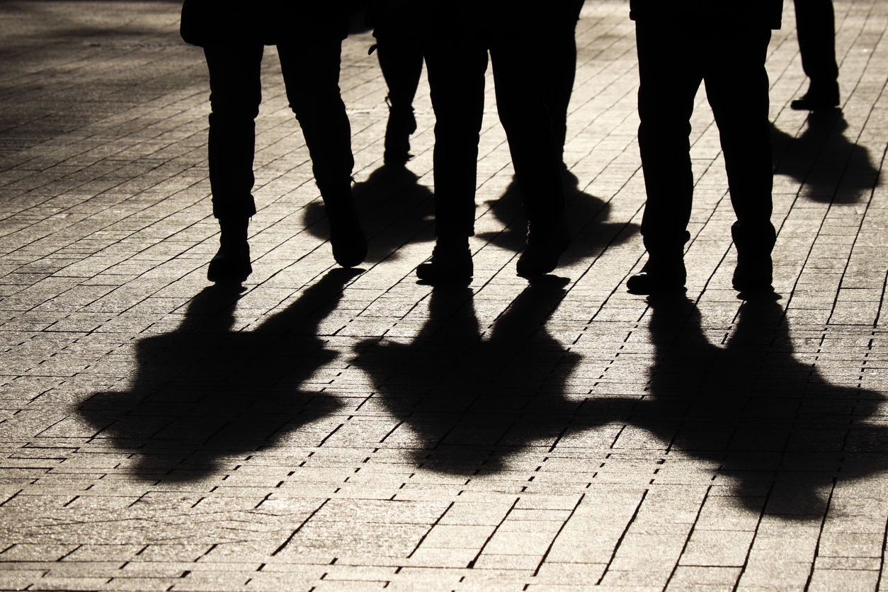 Crowd walking down on sidewalk, concept of strangers, crime, society, epidemic, population