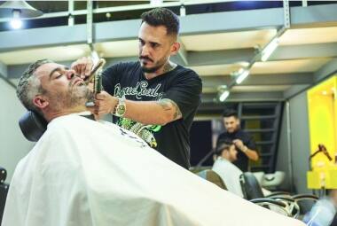 Barba feita Wanderson Ribeiro, da Haircuts, ajuda o gerente comercial Gustavo Madureira a mante