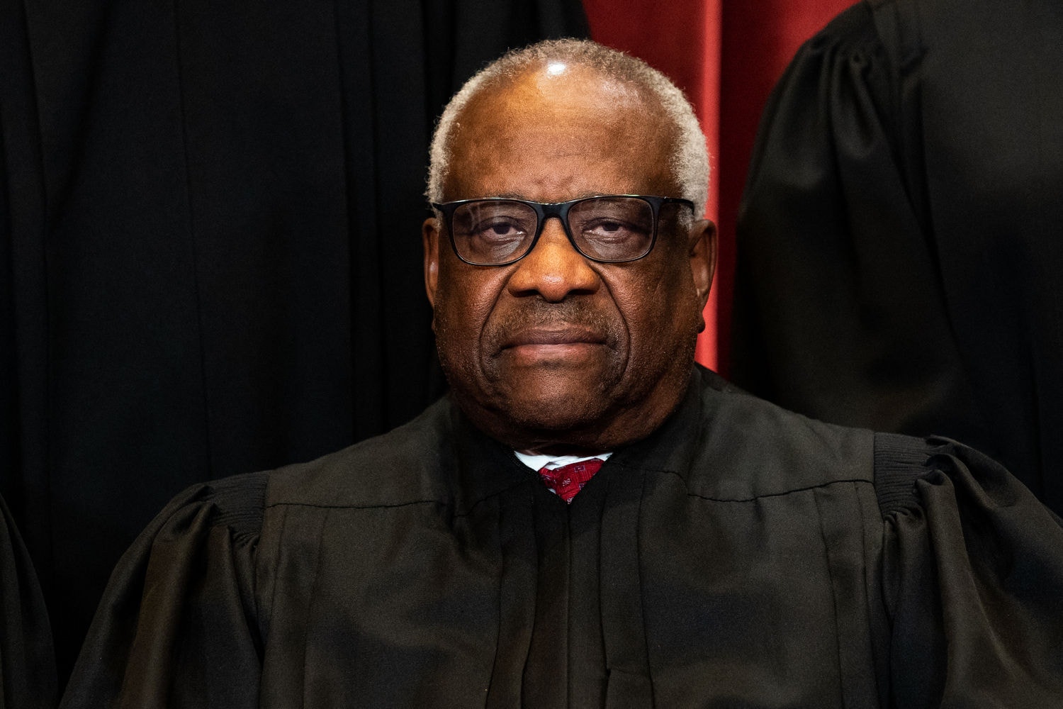 (FILES) Associate Justice Clarence Thomas sits during a group photo of the Justices at the Supreme Court in Washington, DC on April 23, 2021. US Supreme Court Justice Clarence Thomas, who has found himself under scrutiny over his judicial decisions and accepting lavish gifts from a billionaire Republican, is dismissing the criticism as "nastiness" and "lies," according to US media on May 11, 2024. (Photo by Erin Schaff / POOL / AFP)