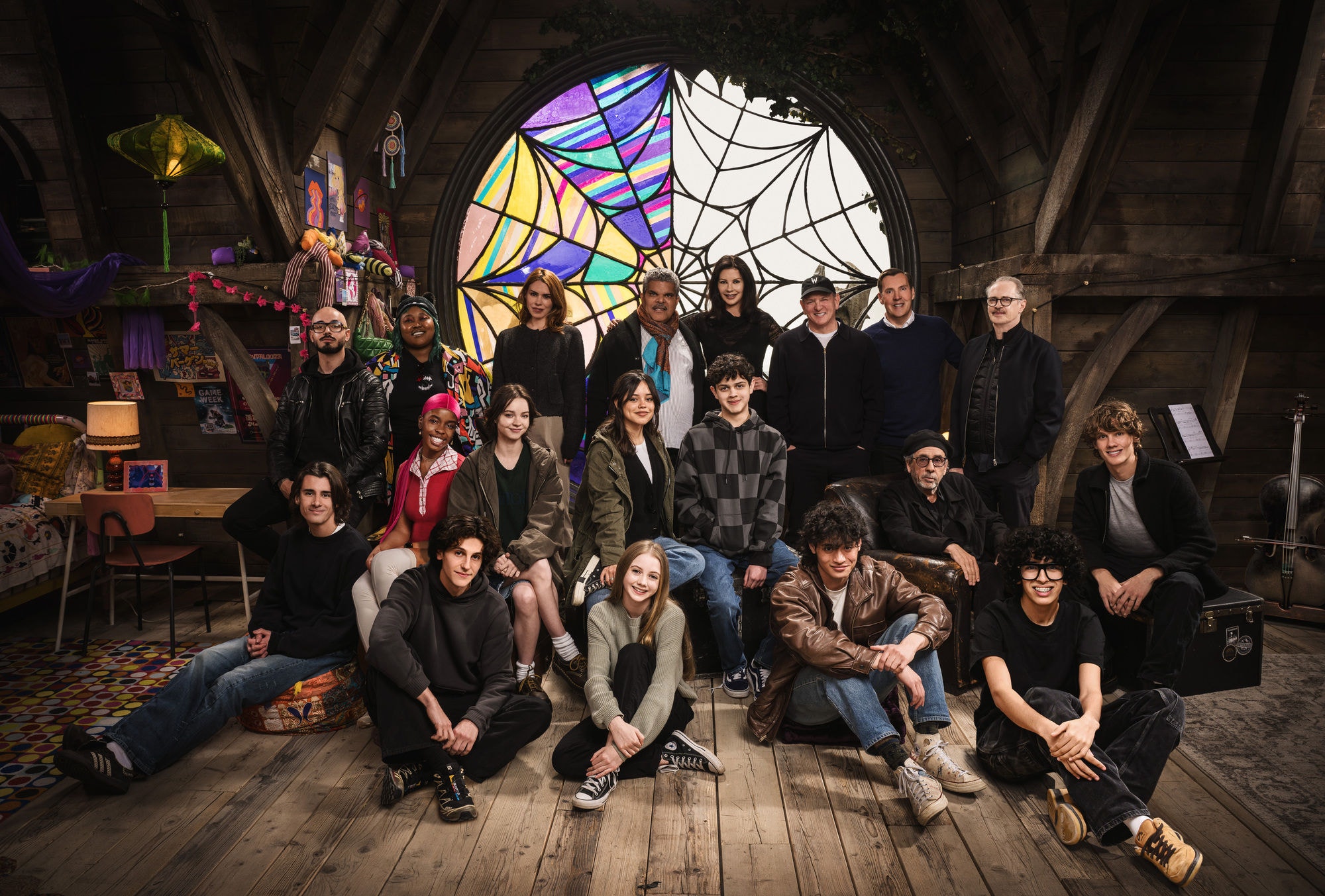 Wednesday. (L to R) Georgie Farmer, Victor Dorobantu, Luyanda Unati Lewis-Nayo, Joy Sunday, Owen Painter, Emma Myers, Billie Piper, Jenna Ortega, Evie Templeton, Luis Guzmán, Isaac Ordonez, Catherine Zeta-Jones, Alfred Gough, Noah Taylor, Miles Millar, Tim Burton, Steve Buscemi, Moosa Mostafa, Hunter Doohan on the set of Wednesday season 2. Cr. Helen Sloan/Netflix © 2024