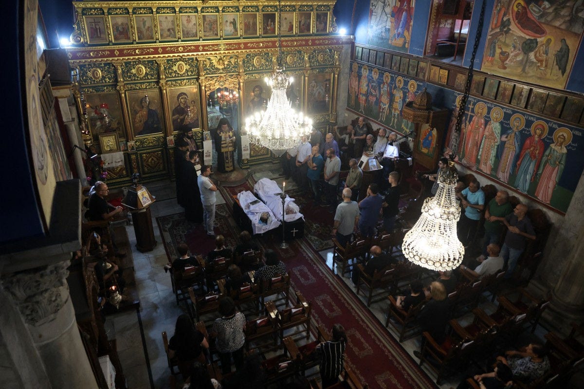 Christian Palestinian mourners attend the funeral ceremony of Saad Salameh and Foumia Ayyad, killed earlier in an Israeli strike that hit the Holy Family church in Gaza City, as Archbishop Alexios of the Saint Porphyrius Church leads the mass on July 17, 2025. An Israeli strike on Gaza's only Catholic church killed three people on July 17, the Latin Patriarchate of Jerusalem said, as Israel said it "never targets" religious sites and regretted any harm to civilians. (Photo by Omar AL-QATTAA / AFP)
