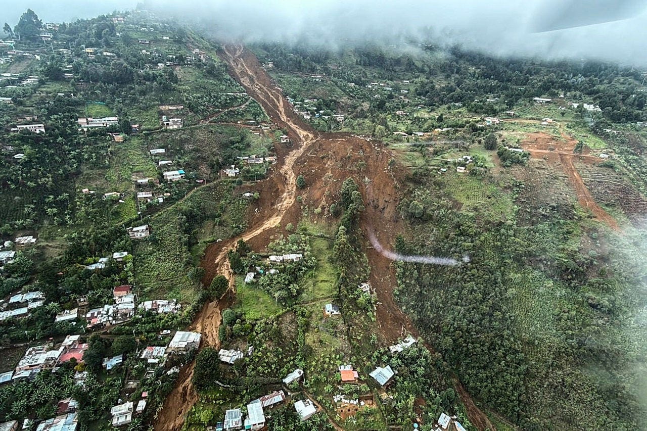 This handout picture released by the Antioquia's Government shows an aerial view of houses buried after a landslide in Bello, Colombia on June 24, 2025. A landslide triggered by heavy rains killed at least eight people and injured five others near the Colombian city of Medellin on June 24, 2025, the local mayor said. (Photo by Handout / Antioquia Government / AFP) / RESTRICTED TO EDITORIAL USE - MANDATORY CREDIT "AFP PHOTO / ANTIOQUIA'S GOVERNMENT" - HANDOUT - NO MARKETING NO ADVERTISING CAMPAIGNS - DISTRIBUTED AS A SERVICE TO CLIENTS