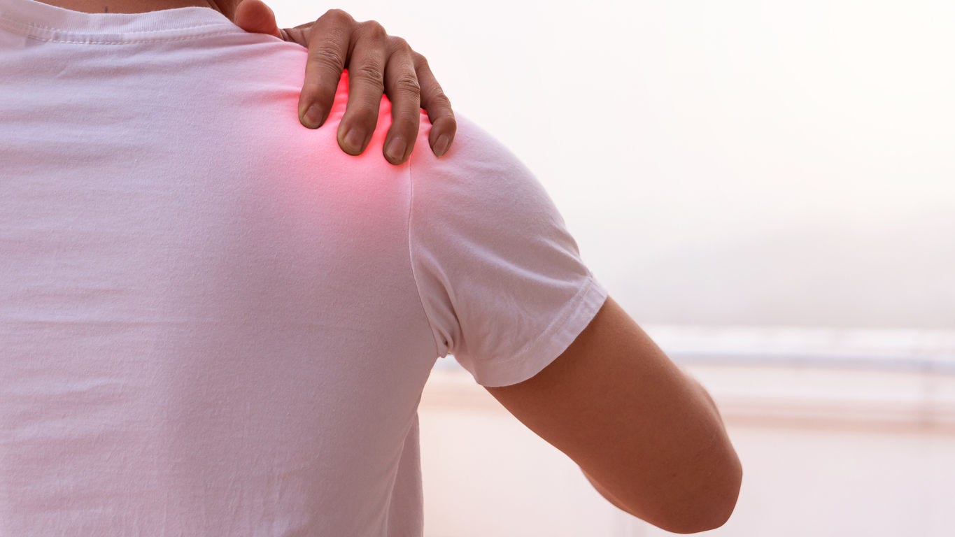 The man who is pain in the shoulder and uses the hand to massage to get the pain.