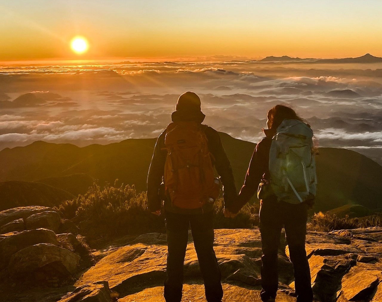 Casal observa o nascer do sol no pico da Bandeira, um dos locais mais frios de Minas