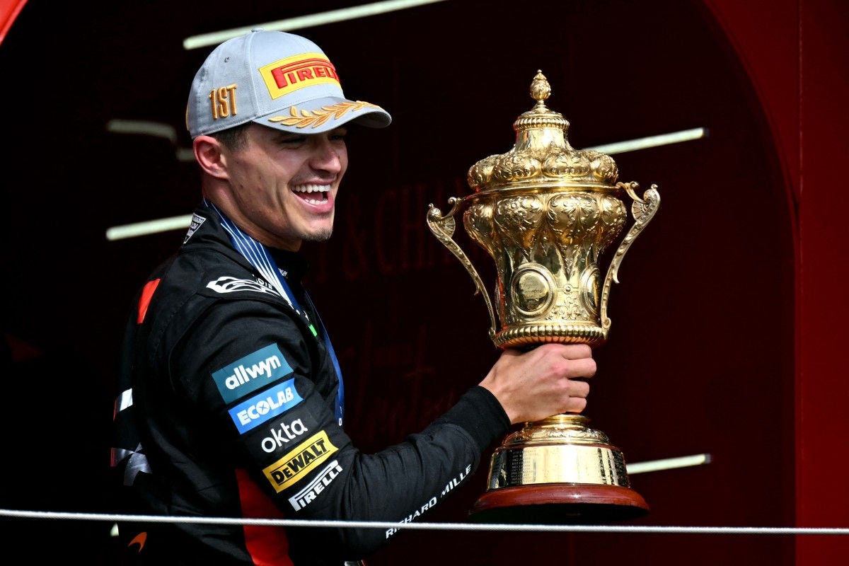 McLaren's British driver Lando Norris lifts the first place trophy after winning the Formula One British Grand Prix at the Silverstone motor racing circuit in Silverstone, central England, on July 6, 2025. (Photo by Andrej ISAKOVIC / AFP)