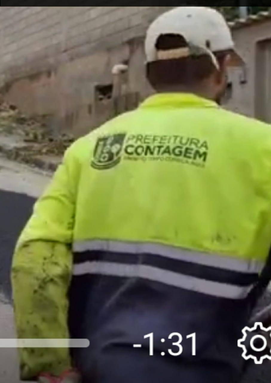 Trabalhador com uniforme da Prefeitura de Contagem, realiza obra de tapa-buraco no bairro Maria Adélia, em Santa Luzia