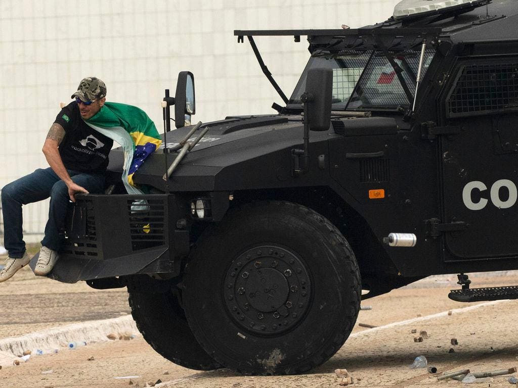 Extremista sobe em carro de choque da Policia Federal que faz a segurança próximo ao prédio do STF, durante os atos criminosos de 8 de janeiro