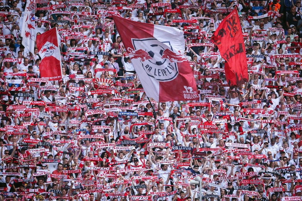 Supporters of RB Leipzig cheer for their team during the German first division Bundesliga football match between RB Leipzig and Werder Bremen in Leipzig, eastern Germany on May 11, 2024. (Photo by RONNY HARTMANN / AFP) / DFL REGULATIONS PROHIBIT ANY USE OF PHOTOGRAPHS AS IMAGE SEQUENCES AND/OR QUASI-VIDEO