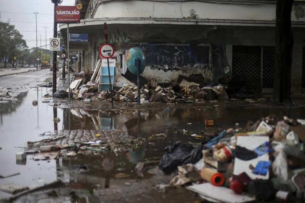 A pile of damaged furniture is seen on a street in Porto Alegre, Rio Grande do Sul State, Brazil, on May 24, 2024. The key agricultural state of Rio Grande do Sul has been hit by an unprecedented climate disaster for the past three weeks, with cities and rural areas alike inundated by torrential rains that have left more than 150 people dead and some 100 missing. (Photo by Anselmo Cunha / AFP)