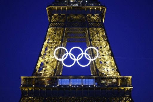 The Olympic rings are illuminated on the Eiffel Tower on June 7, 2024, ahead the upcoming Paris 2024 Olympic Games. (Photo by Ludovic MARIN / AFP)