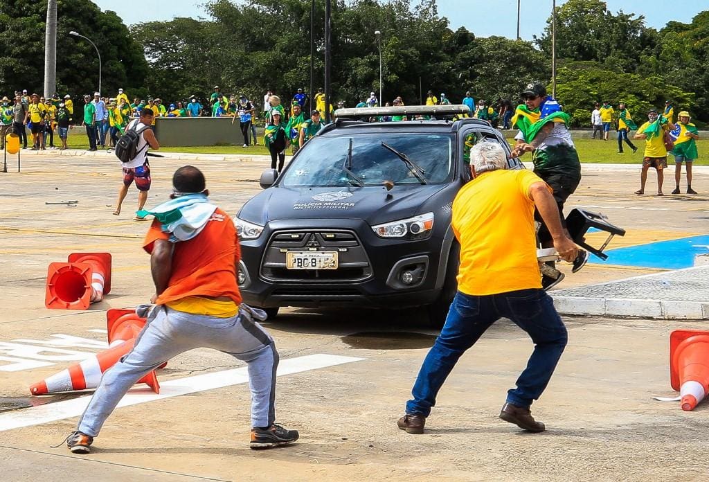 Viatura da Polícia Militar é cercada e atacada por vândalos na Praça dos Três Poderes, em Brasília, durante os atos violentos de 8 de janeiro de 2023