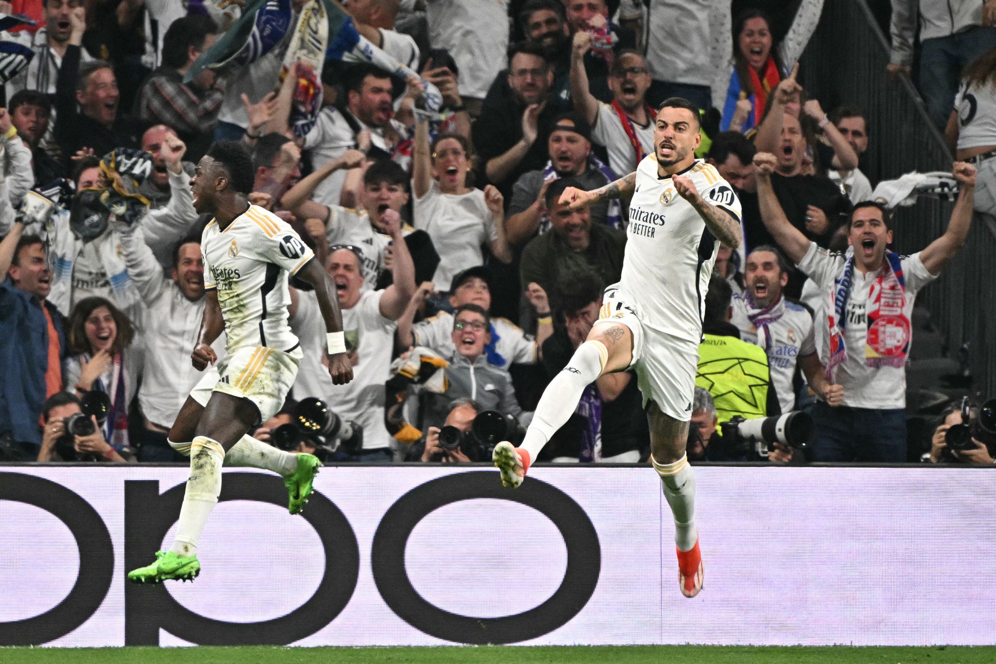 Real Madrid's Spanish forward #14 Joselu (R) celebrates scoring the equalizing goal during the UEFA Champions League semi final second leg football match between Real Madrid CF and FC Bayern Munich at the Santiago Bernabeu stadium in Madrid on May 8, 2024. (Photo by JAVIER SORIANO / AFP)