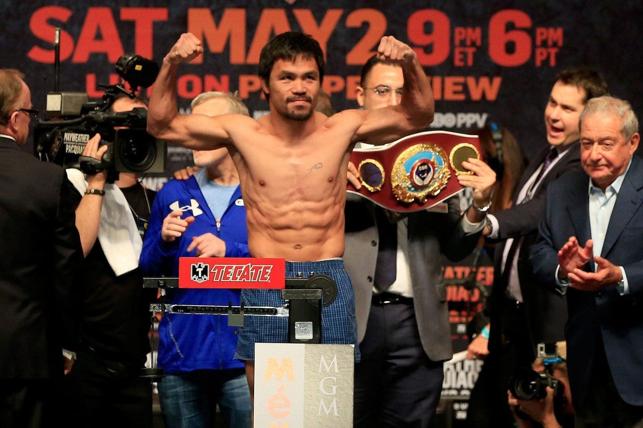 LAS VEGAS, NV - MAY 01: Manny Pacquiao poses on the scale during his official weigh-in on May 1, 2015 at MGM Grand Garden Arena in Las Vegas, Nevada. Pacquiao will face Floyd Mayweather Jr. in a welterweight unification bout on May 2, 2015 in Las Vegas.   Jamie Squire/Getty Images/AFP